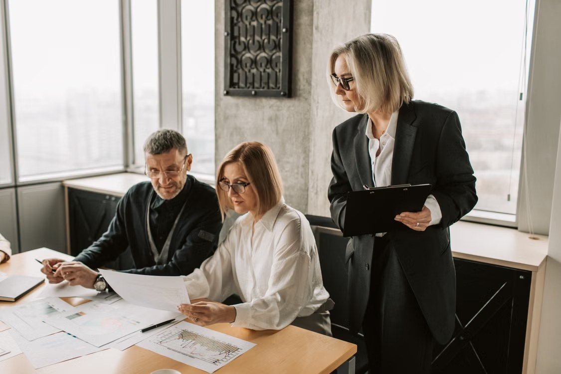 Professionals reviewing documents together around a meeting table